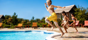 Kids jumping in a swimming pool